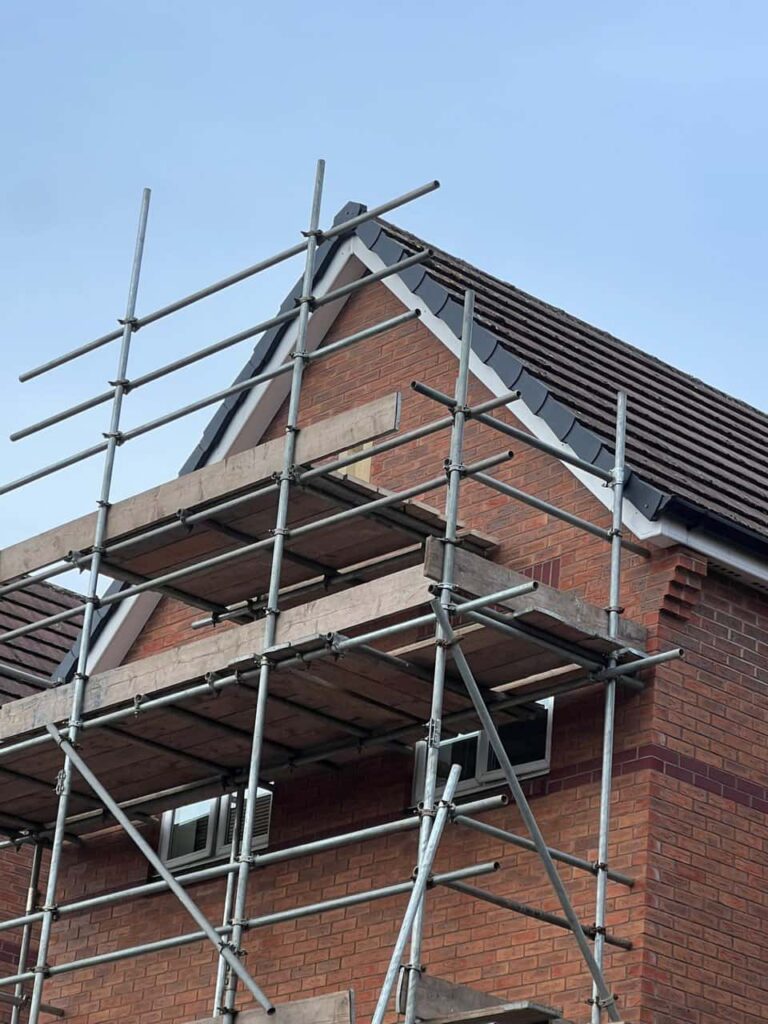 This is a photo of a roof which has just been repaired. There is a scaffold located at the gable end for access onto the roof. Works carried out by MCM Roofing Repairs Blandford Forum